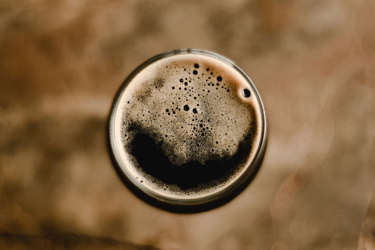 A low-ABV session stout viewed from above showing a perfect creamy foam head in a pint glass